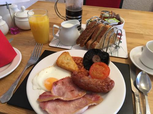 a plate of breakfast food on a table at Earlston House in Paignton