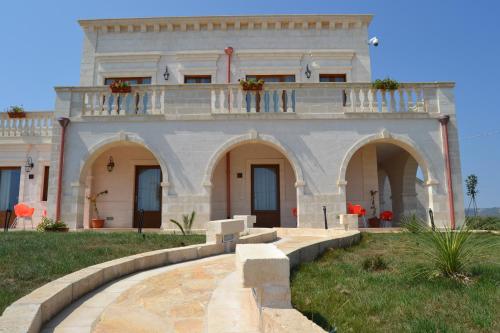 a large building with a balcony on top of it at Agriturismo I Pozzetti in Savelletri di Fasano