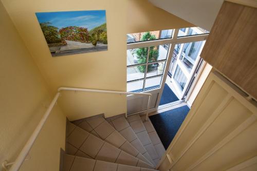 an overhead view of a staircase with a large window at Land-gut-Hotel BurgBlick in Bad Kreuznach