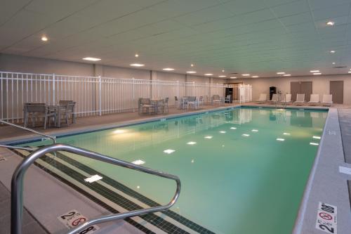 a large swimming pool in a building at Cottonwood Airport & Expo Hotel Louisville in Louisville