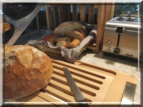 a loaf of bread sitting on a table next to a toaster at Hotel et Appartements Reine D'Azur in Roquebrune-Cap-Martin