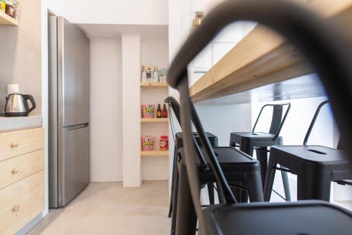 a kitchen with a stove top oven and cabinets at Bedspot Hostel in Fira