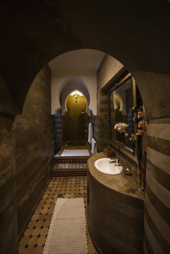 a bathroom with a sink and a mirror at Riad Maison Belbaraka in Marrakesh