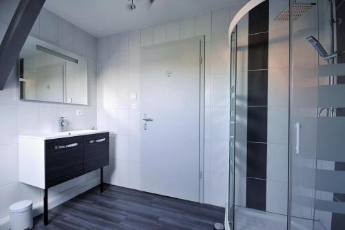 a bathroom with a sink and a shower at Fleur de Vigne in Eguisheim