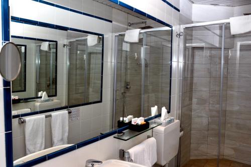 W łazience znajduje się prysznic i umywalka. w obiekcie Hotel Helios w mieście Santa Margherita Ligure