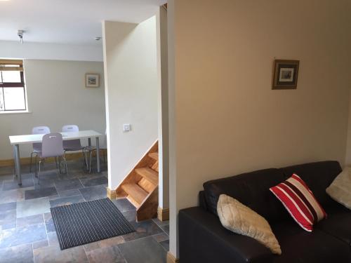 a living room with a couch and a table at Redington House SelfCatering accommodation in Cobh