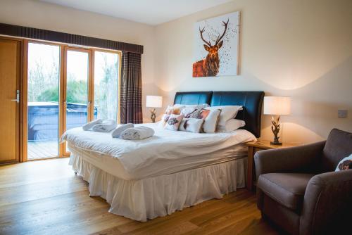 a bedroom with a large bed and a couch at Clovenstone Lodges in Inverurie
