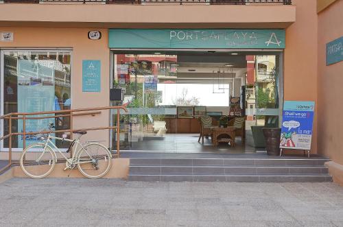 a bike parked in front of a store front at Sea You Apartamentos Valencia Port Saplaya in Port Saplaya