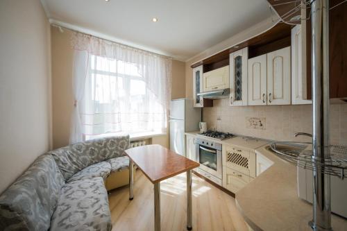 a kitchen with a couch and a table in a room at Апартаменты на площади Ленина от ApartmentCity in Mogilev