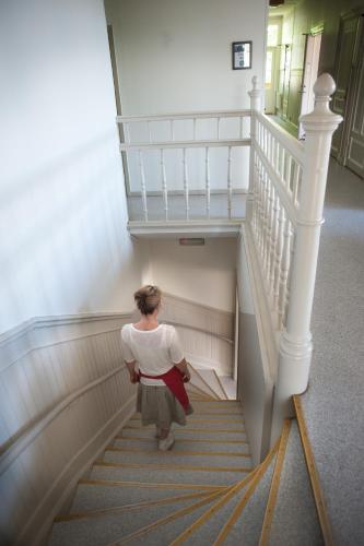 a woman walking down a stairway at Ronneby Brunnspark Vandrarhem och B&B in Ronneby