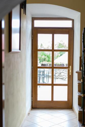 a wooden door with a window in a room at Penzion U Hrádku in Kutná Hora