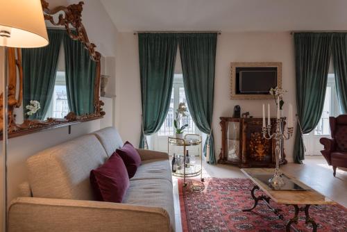 a living room with a couch and a table at Corte Realdi Luxury Rooms Torino in Turin