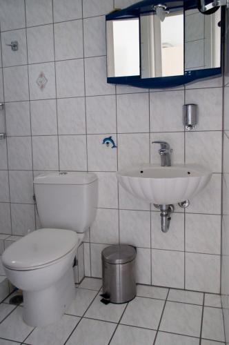 a bathroom with a toilet and a sink at Hara's Studio in Perdhika