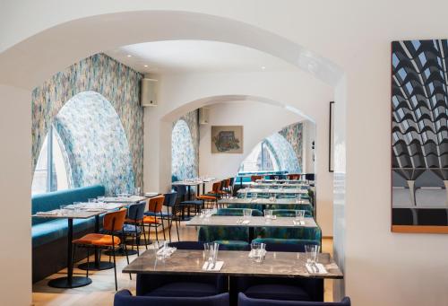 une rangée de tables et de chaises dans un restaurant dans l'établissement Galleria Vik Milano - Townhouse Galleria - Small Luxury Hotels of the World, à Milan