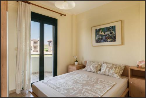 a bedroom with a bed and a large window at Oxana house in Nea Moudania