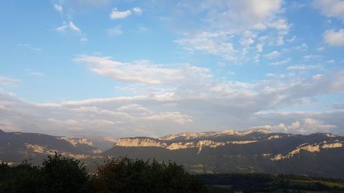 a view of a mountain range under a cloudy sky at Le Mas de Chartreuse in Miribel-les-Échelles