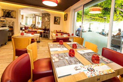 a restaurant with tables and chairs and a window at Auberge du Bon Vivant in Argelès-sur-Mer