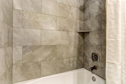a bathroom with a bath tub and a sink at Beachside Motel - Amelia Island in Amelia Island