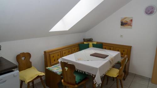 a kitchen with a table and chairs with a white tablecloth at Ferienwohnung Bucher Ursula in Waldmünchen