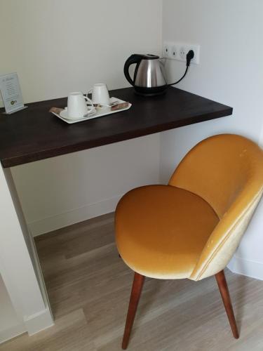 a chair sitting in front of a table at la blanchetière in Francueil