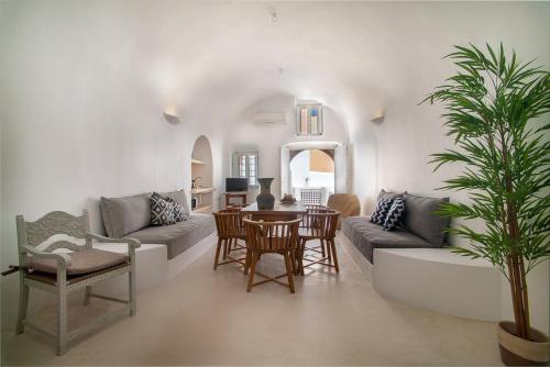 a living room with a couch and a table at Radiant Santorini in Mesaria