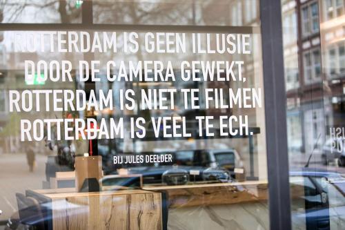 a sign in the window of a store at Leonardo Hotel Rotterdam Savoy in Rotterdam