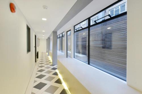 a hallway of a house with large windows at Wigmore Suites Serviced Apartments by Globe Apartments in London