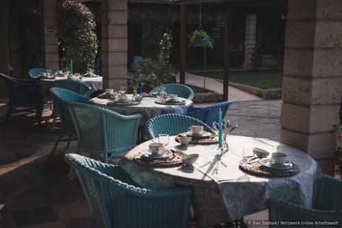 a group of tables and chairs with dishes on them at Sa Vaqueria in Porto Cristo