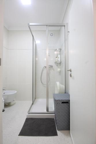 a white bathroom with a shower and a sink at Salinas Beach House - T3 Apartment - Costa Nova in Costa Nova