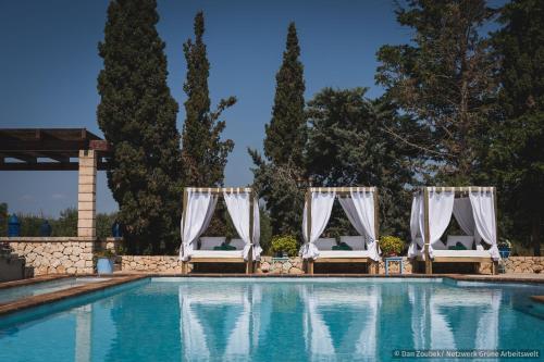 a pool with two chairs and a set up for a wedding at Sa Vaqueria in Porto Cristo
