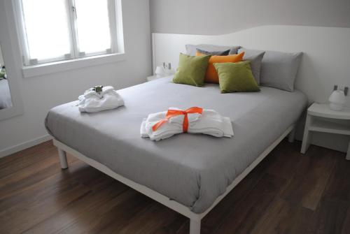 a bed with two towels on top of it at DolceLago in Sirone