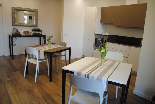 a kitchen and dining room with two tables and chairs at DolceLago in Sirone