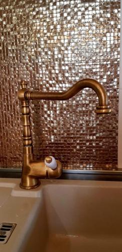 a brass bathroom sink with a copper faucet at Villa Duboka, Otok Vis in Komiža