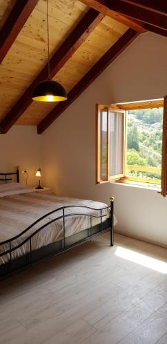 a bedroom with a bed and a large window at Villa Duboka, Otok Vis in Komiža