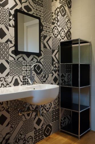 a bathroom with a sink and a mirror on a wall at Villa Crassula in Casarza Ligure