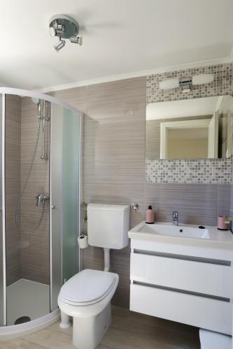 a bathroom with a toilet and a sink and a shower at PERE in Korčula