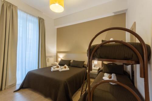 a bedroom with a bunk bed with two dolls on it at B&B Cairoli in Messina