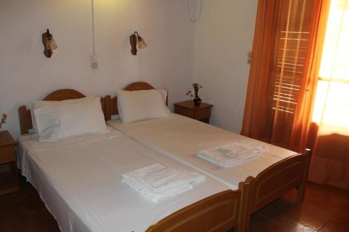 a bedroom with a bed with two towels on it at Smile 2 in Kassiopi