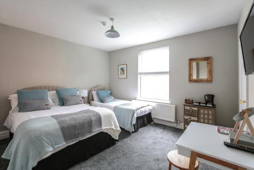 a bedroom with two beds and a window at Baytree Lodge Chester in Chester