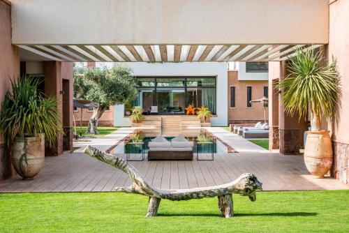 a house with a lizard statue in the yard at Zagora and Marhba villas Marrakech - by EMERALD STAY in Marrakech
