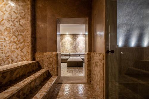 a bathroom with a mirror and a bed in a room at Zagora and Marhba villas Marrakech - by EMERALD STAY in Marrakech