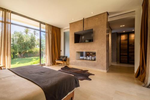 a bedroom with a large bed and a large window at Zagora and Marhba villas Marrakech - by EMERALD STAY in Marrakech