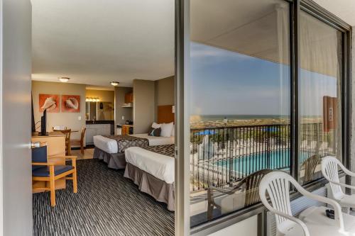 um quarto de hotel com duas camas e uma varanda em Beachside Motel - Amelia Island em Amelia Island