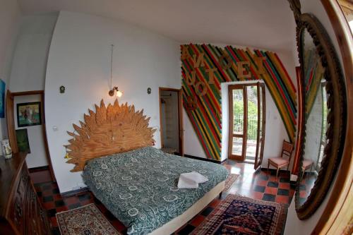 a bedroom with a bed and a large mirror at villa eolo in Vernazza