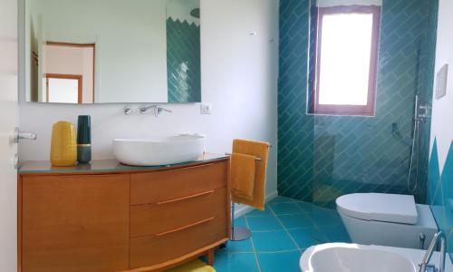 a bathroom with a sink and a toilet at Apulia Beach in Leporano