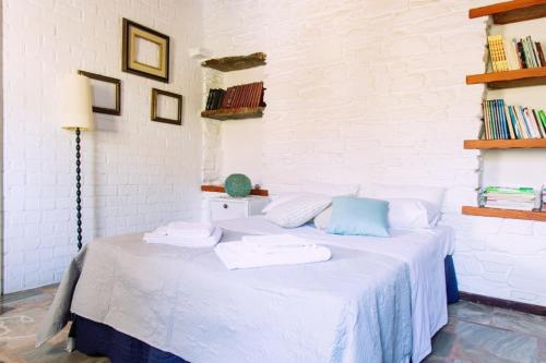 a white bed with towels on it in a room at Sun Holiday House in Pisses