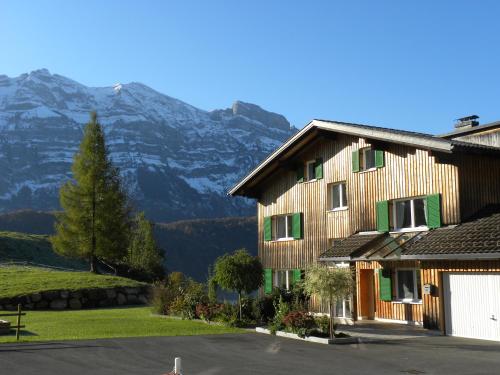 a large building with a mountain in the background at Ferienhaus Bergland in Bizau