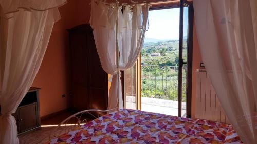 a bedroom with a bed and a large window at Domus Quarticelli Costa dei Trabocchi in Torino di Sangro