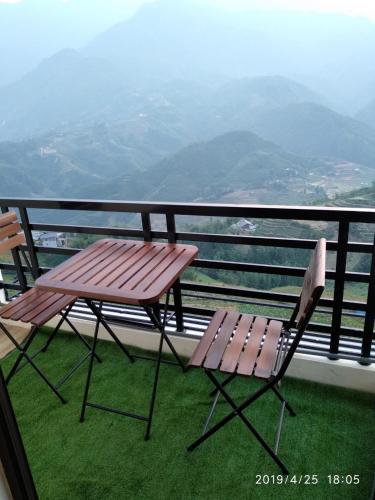 a bench and a chair sitting on a balcony at Sapa Valley view hotel in Sa Pa