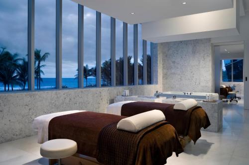 
a hotel room with two beds and a large window at Fontainebleau Miami Beach in Miami Beach
